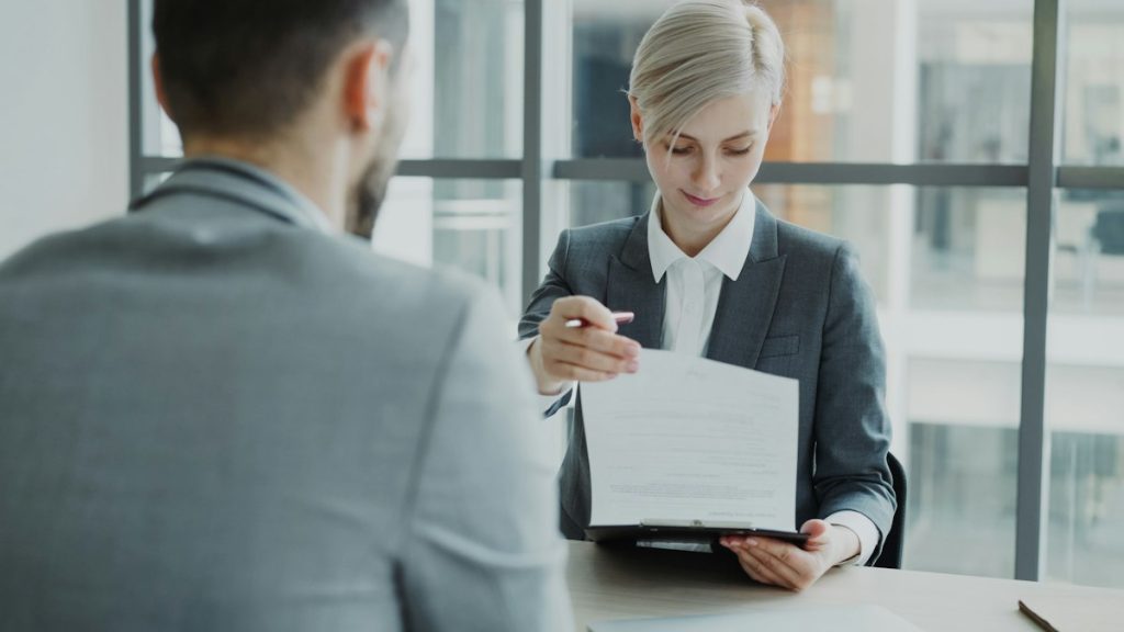 Attorney reviewing bankruptcy petition documents with client