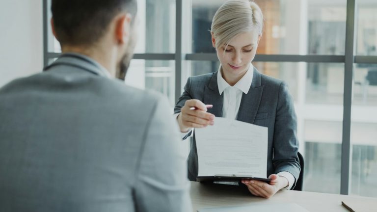 Attorney reviewing bankruptcy petition documents with client